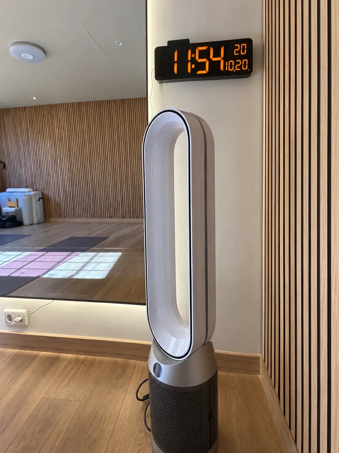 Air purifier and digital clock beside the movement room mirror