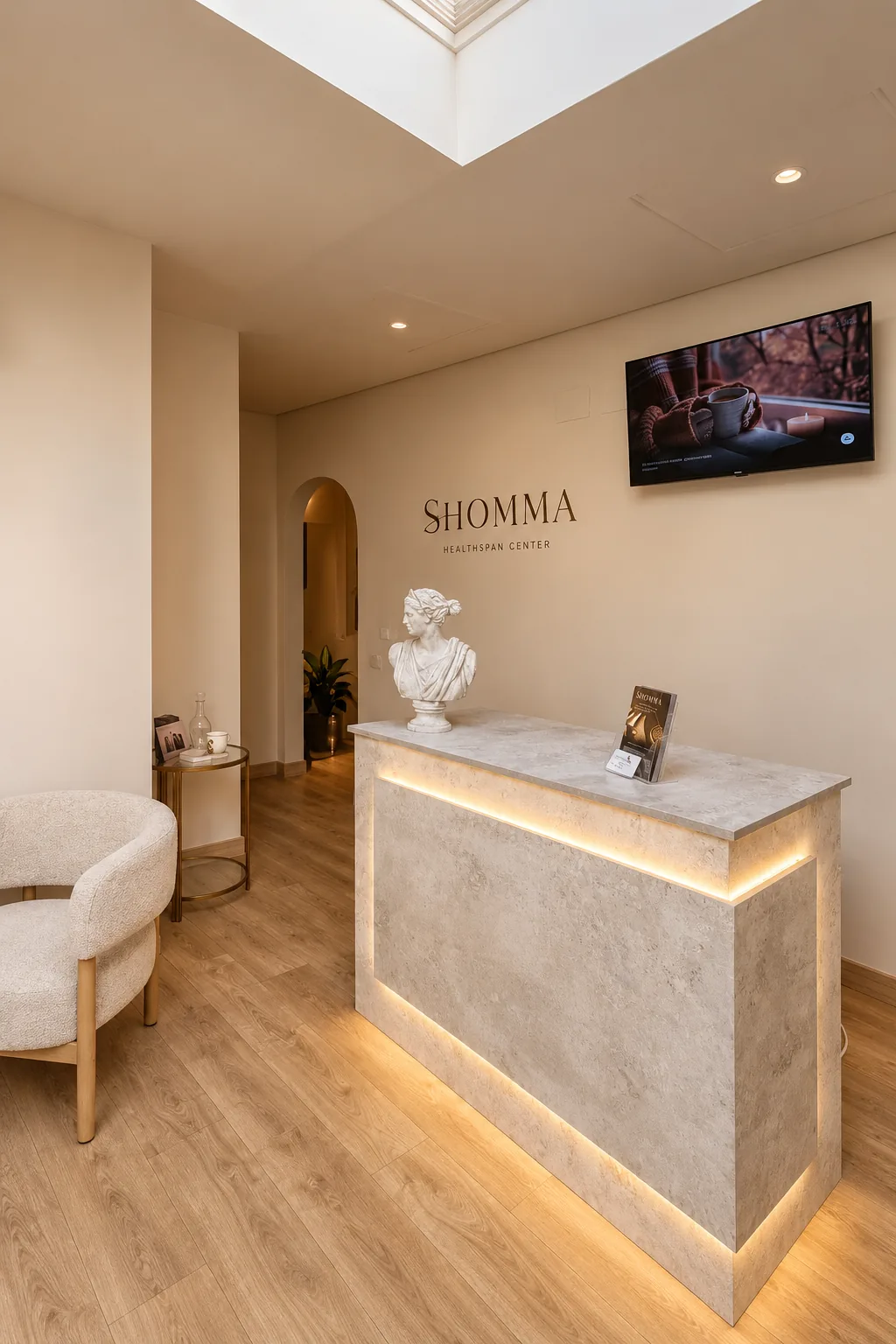 Stone reception desk with warm light and a decorative bust